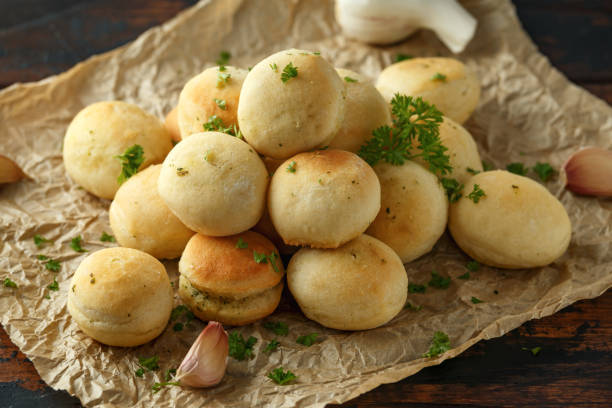 istock Fresh Garlic Ball bread on black plate on crumpled paper 1090574712