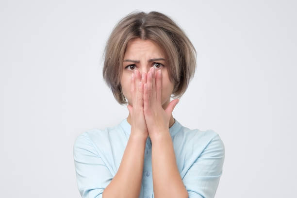istock Scared woman in blue shirt looking at camera. She is afraid to stay alone 1090575530