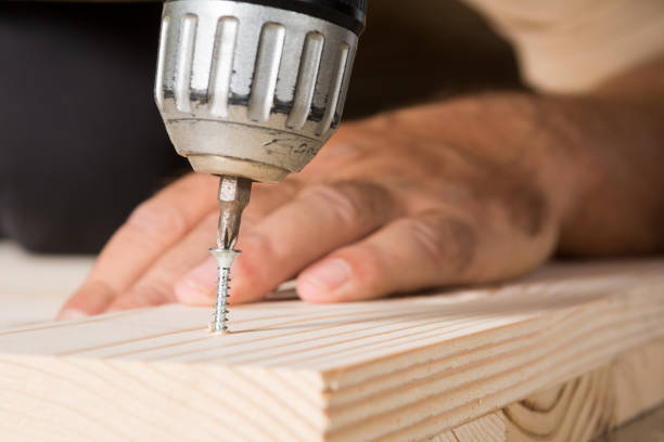 istock Handworker working with an electric screwdriver, close up 1090578568