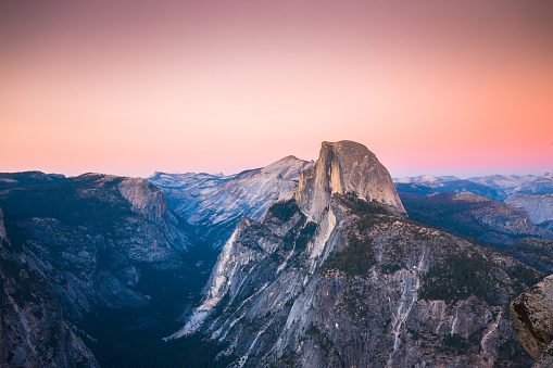 Classic view of famous Half Dome illuminated in beautiful golden evening light at sunset on  a beautiful sunny day with blue sky in summer, Yosemite National Park, California, USA