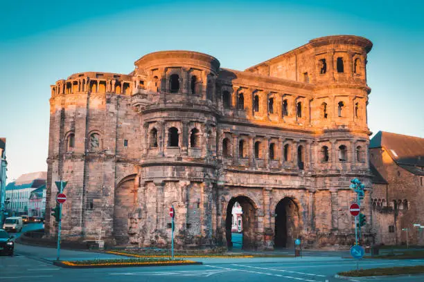 Classic view of famous Porta Nigra, the largest Roman city gate monument north of the Alps, in beautiful golden morning light at sunrise in summer, Rheinland-Pfalz, Germany