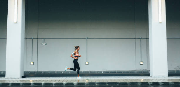 istock Woman jogging in the city 1090581892