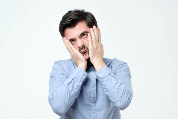 istock Annoyed guy with bristle, leaning face on hand and looking indifferent at camera 1090589340