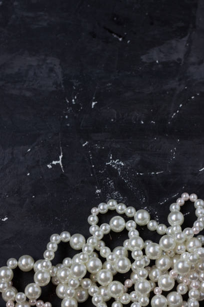 istock white pearl beads on black background, 1090589386