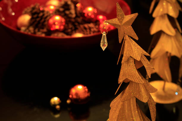istock Funky brass Christmas tree with glitter on warm, low key background 1090592582