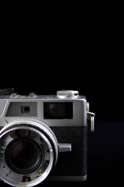 istock Old and damaged rangefinder camera closeup on a black cut out background 1090592872