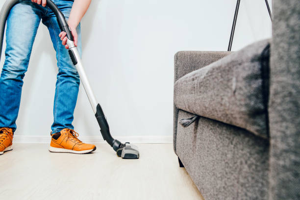 istock The man is vacuuming in the apartment. 1090596910