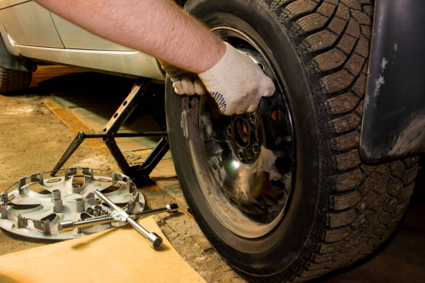 istock Mechanician changing car wheel in garage. Tire service. 1090608576