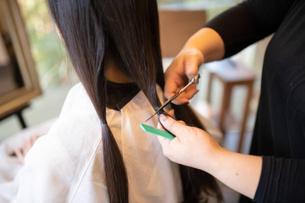 Woman cutting hair for charitable donation Woman cutting hair for charitable donation kamakura city photos stock pictures, royalty-free photos & images