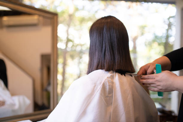 Woman cutting hair for charitable donation Woman cutting hair for charitable donation kamakura city photos stock pictures, royalty-free photos & images