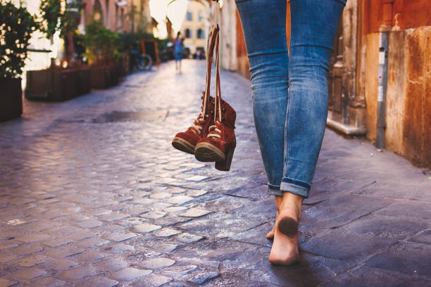 istock Barefoot woman walking on street 1090610868