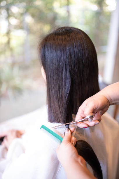 istock Woman cutting hair for charitable donation 1090610926