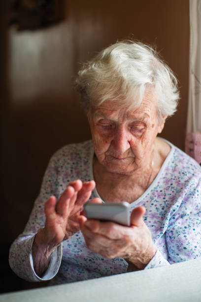 istock Elderly woman sits with a smartphone in her hands. 1090612892