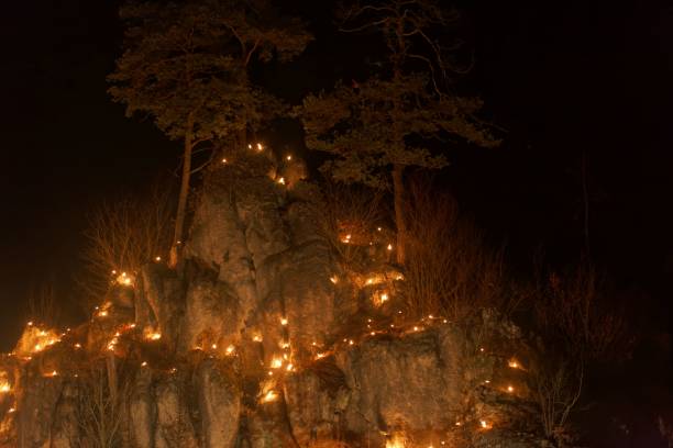 istock Small fires in a rocky hill with trees during a light celebration in the Frankonian Alb, Southern Germany. 1090631196