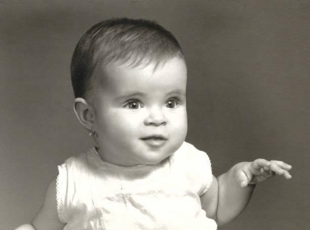 One year old caucasian female baby posing in the sixties