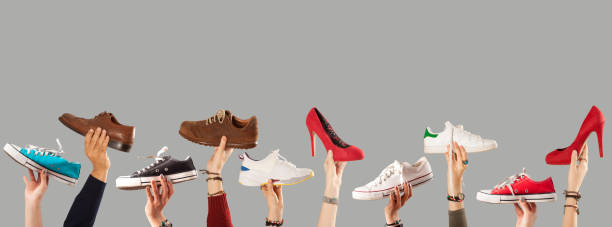 istock arm raised and holding shoes 1090643210