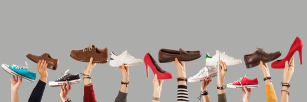 istock arm raised and holding shoes 1090643266