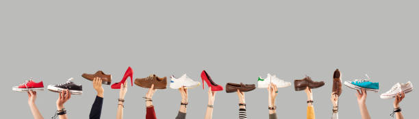 istock arm raised and holding shoes 1090643384