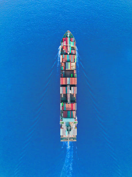 istock Aerial top view container ship on the sea full speed transport container for logistics import export or shipping background. 1090645188