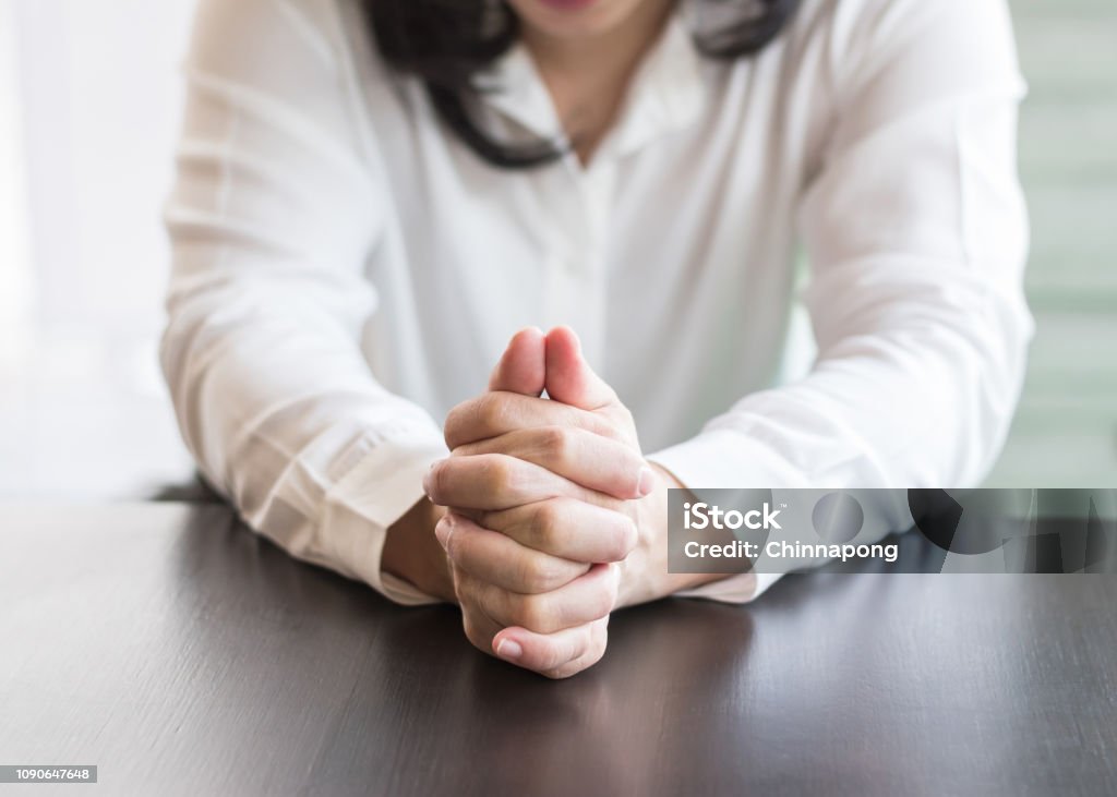 Woman prayer's hands holding together praying in for religious holy spirit, forgiveness, mourning in silence concept Hand Stock Photo