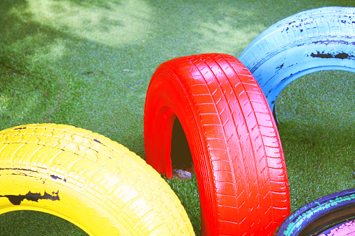 Tire chairs on green grass fake at Playground