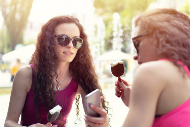 istock Twin sisters eating ice cream 1090647882