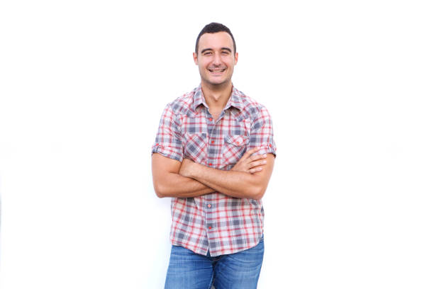 istock smiling man with arms crossed against isolated white background 1090648272