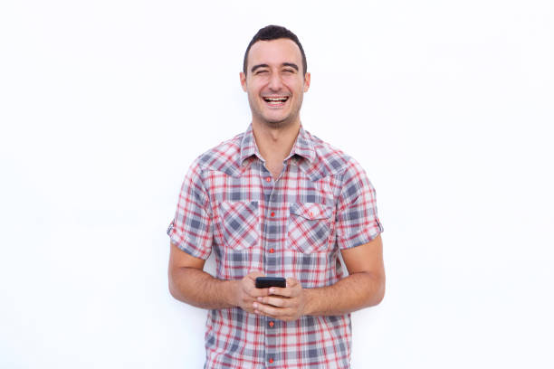 istock laughing man in his 30s holding mobile phone by isolated white background 1090648276