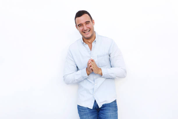 istock attractive man laughing with hands clasp against isolated white background 1090648304