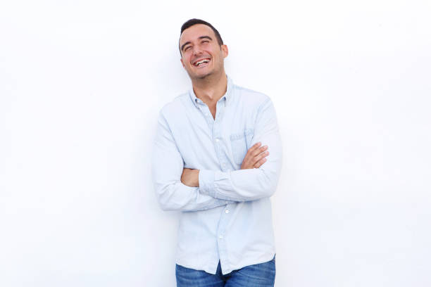 istock attractive man laughing with arms crossed against isolated white background 1090648312