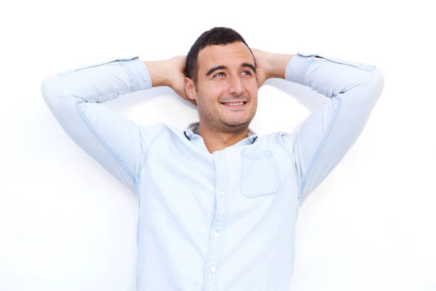 istock older handsome man smiling with hands behind head against white background 1090648348