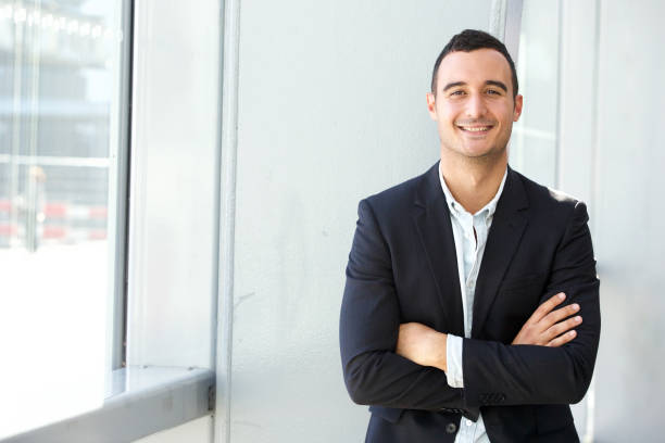 istock happy businessman posing with arms crossed 1090648536