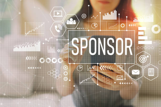 Sponsor with woman using a smartphone Sponsor with woman using her smartphone on a couch sponsorship stock pictures, royalty-free photos & images