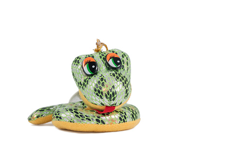 Soft toy small green smiling snake isolated on white background