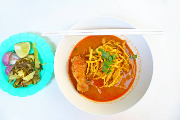istock Egg Noodle in Chicken Curry and side dish which are pickles,lemon slices and shallots (Kao Soi Kai ) 1090660602