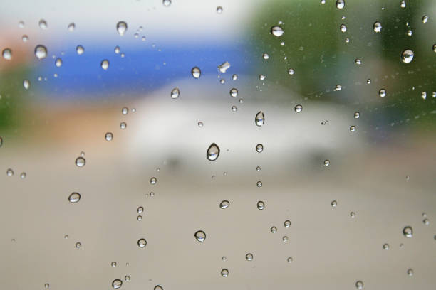 Surface water drops on car glass after the rain