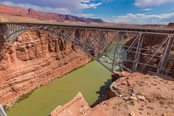 Navajo Bridge steel spandrel arch bridges Navajo Bridge is a pair of steel spandrel arch bridges that cross the Colorado River near Lee's Ferry in northern Arizona. The newer bridge of the pair carries vehicular traffic on U.S. Route 89A (US 89A) over Marble Canyon between southern Utah and the Arizona Strip, allowing travel into a remote region north of the Colorado River including the North Rim of Grand Canyon National Park. Navajo Bridge steel spandrel arch bridges. glen canyon stock pictures, royalty-free photos & images