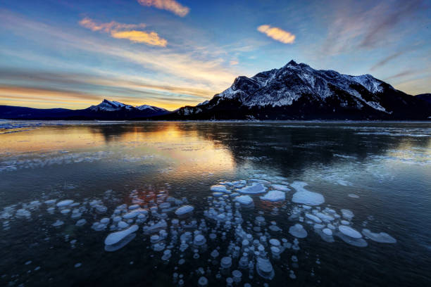istock Sunrise with ice bubbles, Abraham Lake, Clearwater County, AB, Canada. 1090668842