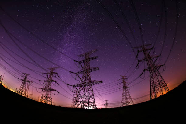 istock High voltage towers at night and the Milky Way 1090668902