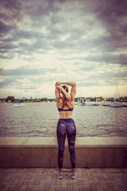 istock Stretching, woman, on the waterfront exercising 1090679388