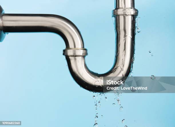 Leaking Of Water From Stainless Steel Sink Pipe On Isolated On Light Blue Background Stock Photo - Download Image Now