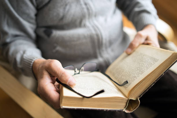 Close up shot of hands opening and reading book.
