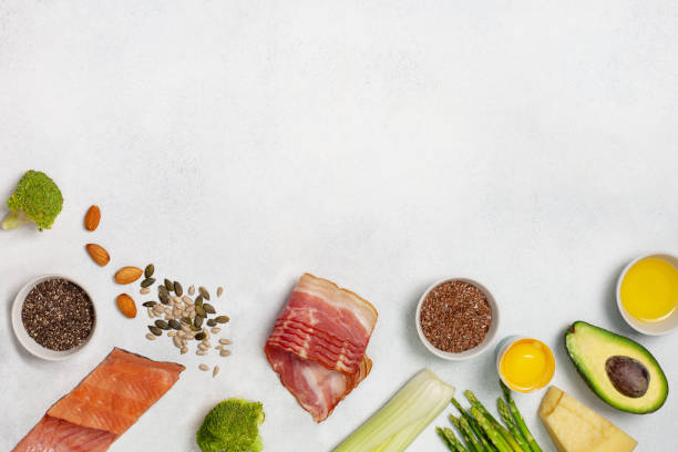 Ingredients for ketogenic diet Ingredients for ketogenic diet: bacon, fish, broccoli, asparagus, avocado,  cheese, sunflower seeds, chia seeds, pumpkin seeds, flax seeds. view from above. copy space ketogenic diet stock pictures, royalty-free photos & images
