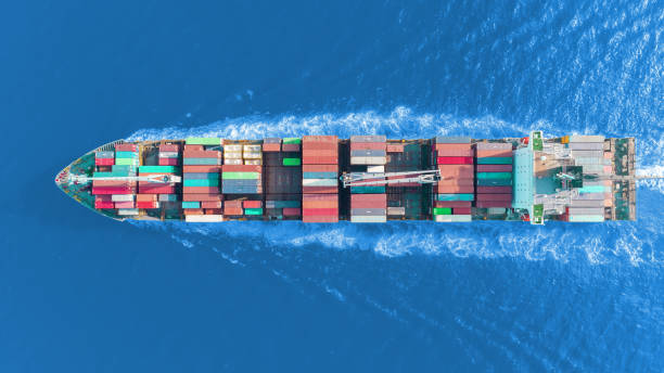 istock Aerial top view container ship on the sea full speed transport container for logistics import export or shipping background. 1090718666