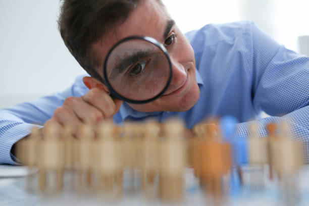 istock Businessman in blue shirt is holding a magnifying 1090723174