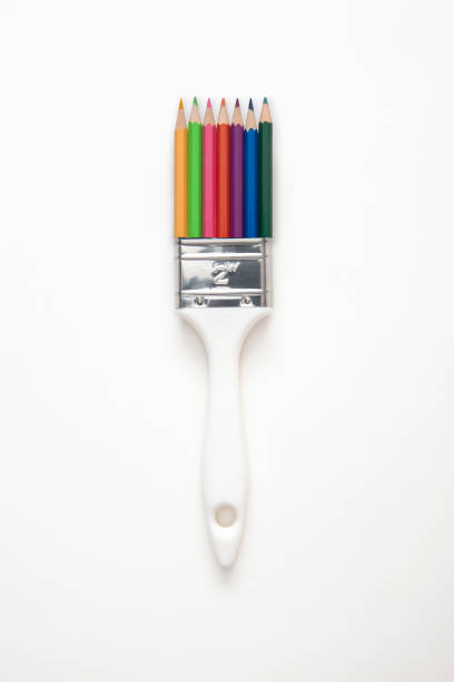 Pencil paintbrush over white background, directly above.