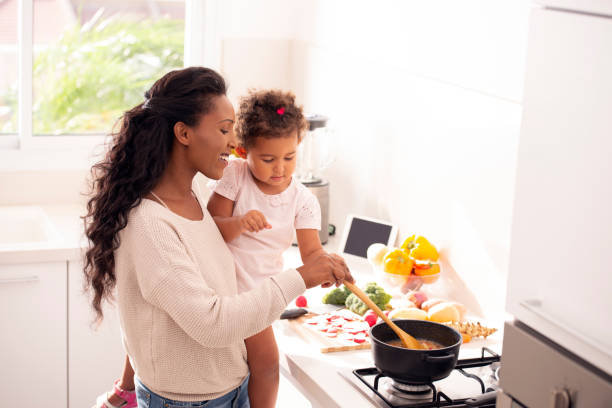 istock Mother and daughter cooking soup together. 1090726854