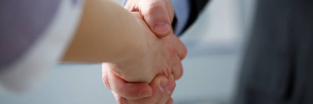 istock Man in suit and tie give hand as hello in office 1090730558