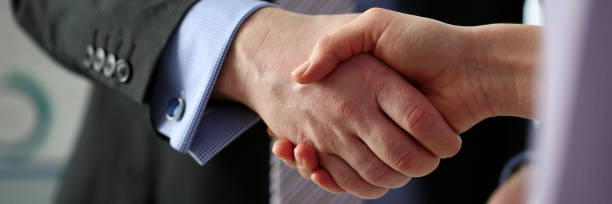 istock Man in suit and tie give hand as hello in office 1090730562