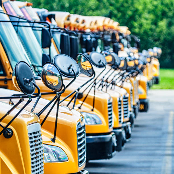 istock Bright Yellow School Buses Parked in High School Parking Lot 1090730838